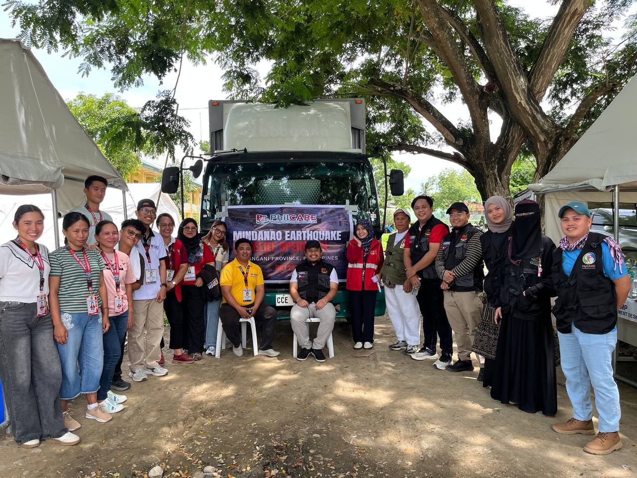 PHILCARE volunteers distributing emergency relief supplies to affected families.