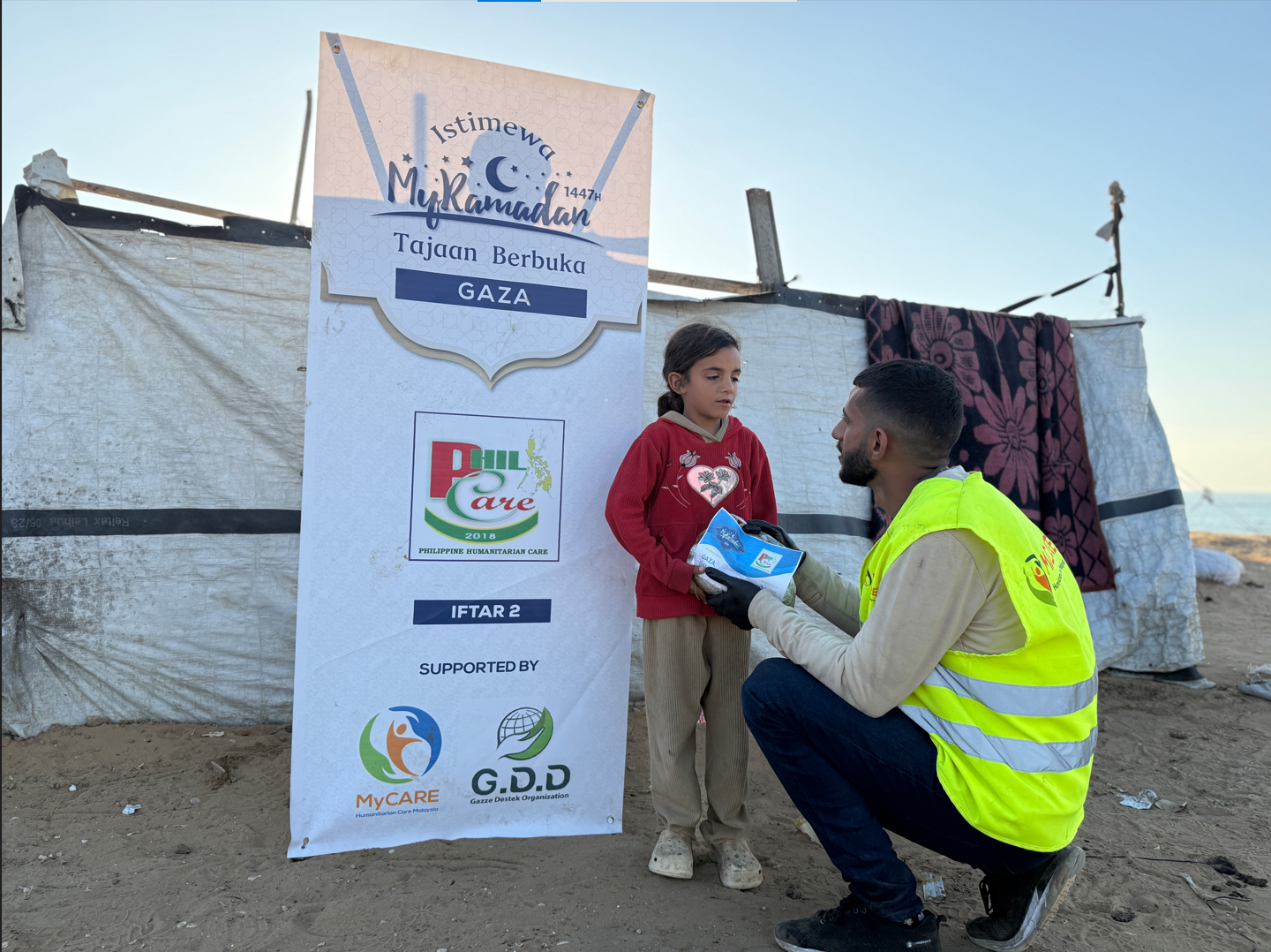 Aid workers distributing relief supplies to families in a displacement camp.